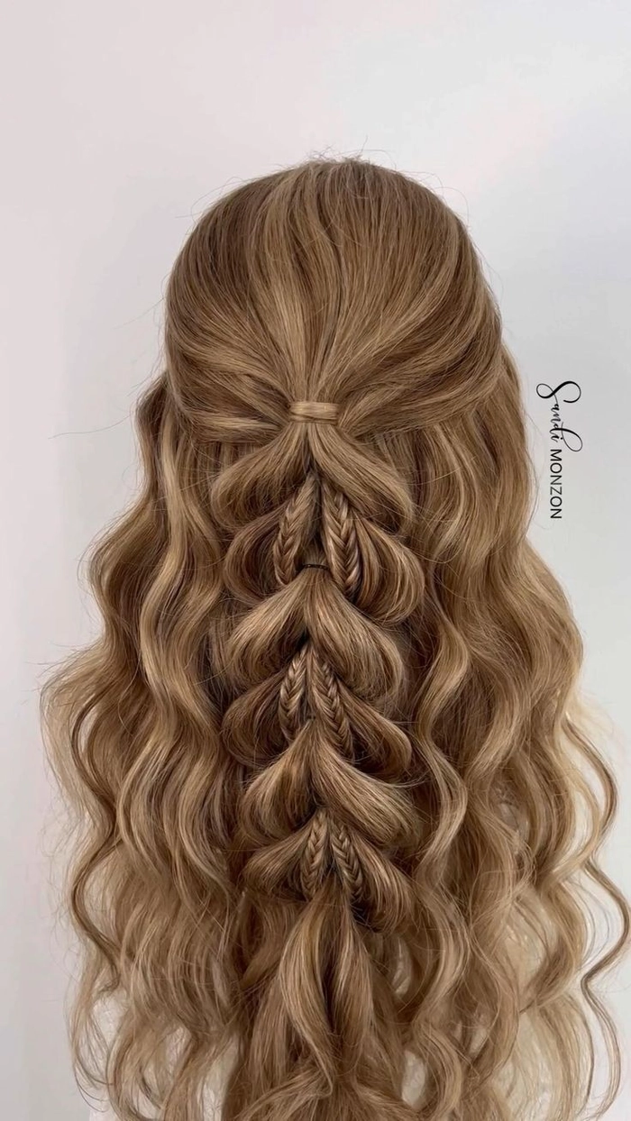 Elegant prom hairstyle featuring multiple small braids woven into a sophisticated updo