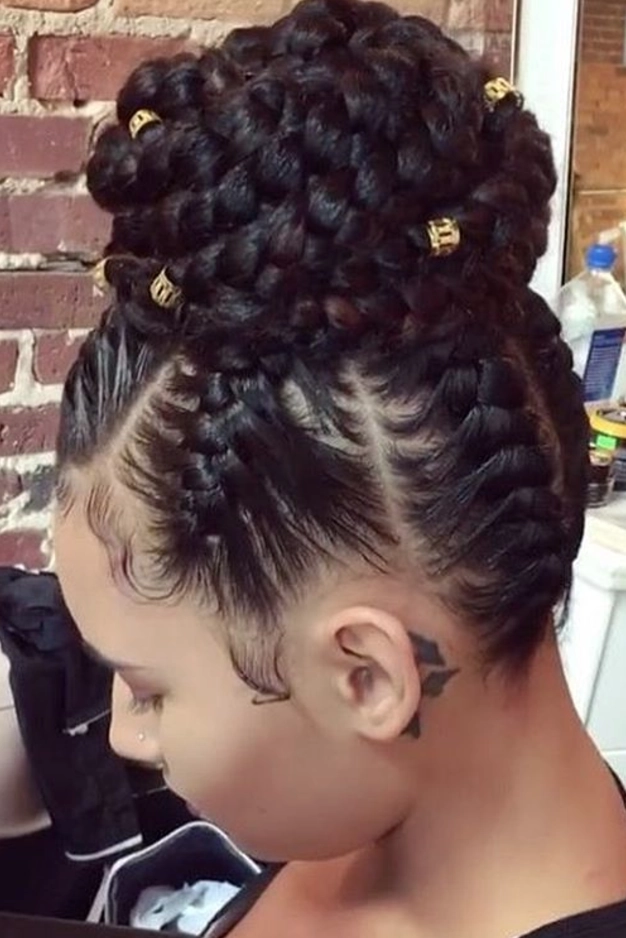 Elegant prom hairstyle featuring multiple small braids woven into an updo