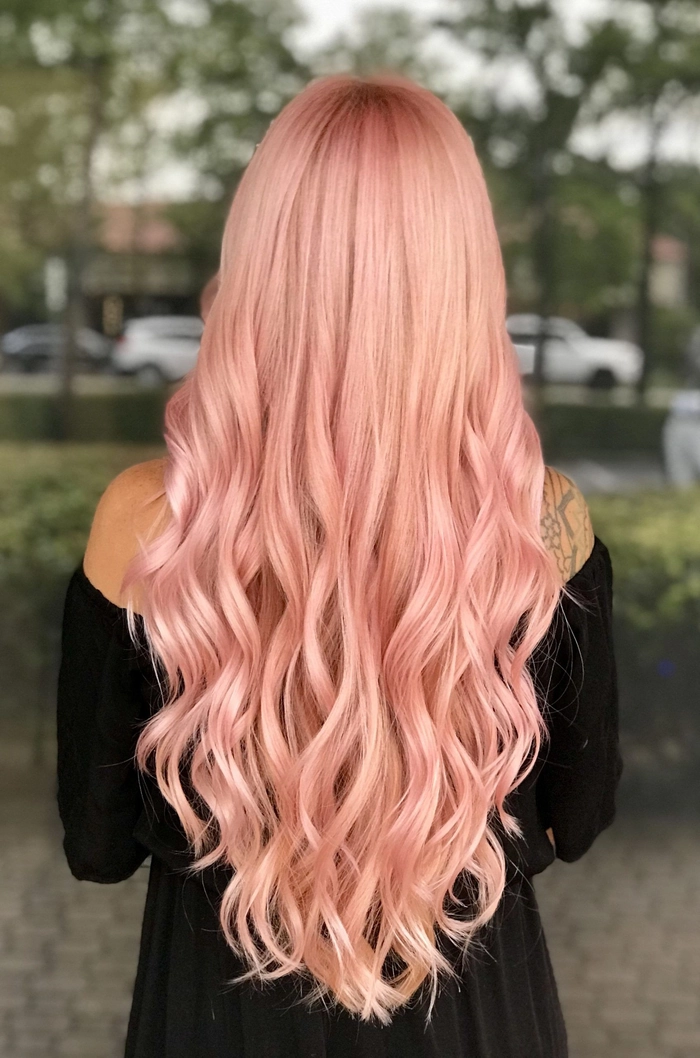 Prom hairstyles for pastel pink dyed hair showcasing a romantic updo Elegant prom hairstyle on pastel pink dyed hair with soft curls