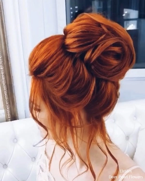 Elegant prom hairstyle featuring vibrant red hair with soft curls