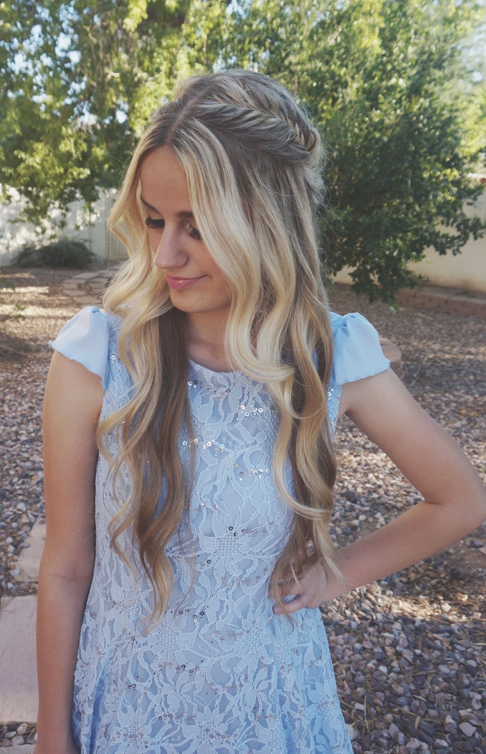 Elegant prom hairstyle with soft curls complementing a blue dress