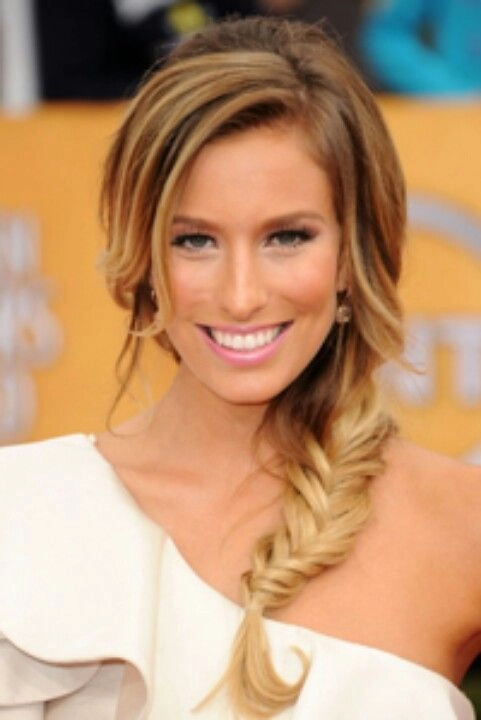 Elegant prom hairstyle showcasing soft curls for one shoulder gowns