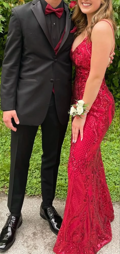 Elegant prom hairstyle featuring soft curls to match a red dress