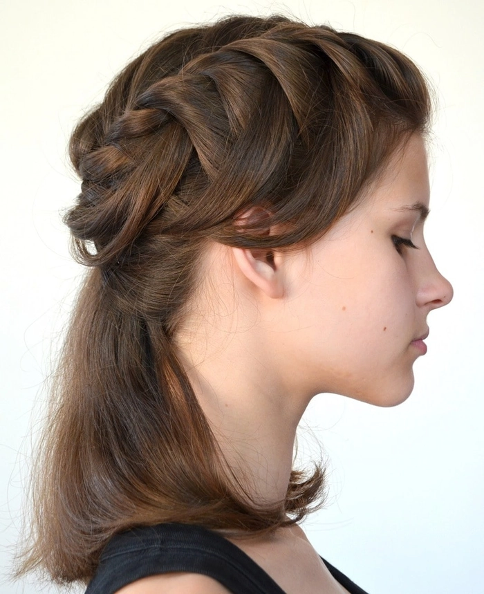 Elegant prom hairstyle featuring a single thick braid cascading over long hair