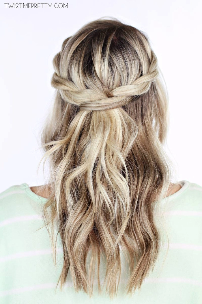 Elegant prom hairstyle featuring a twisted halo braid styled on long flowing hair