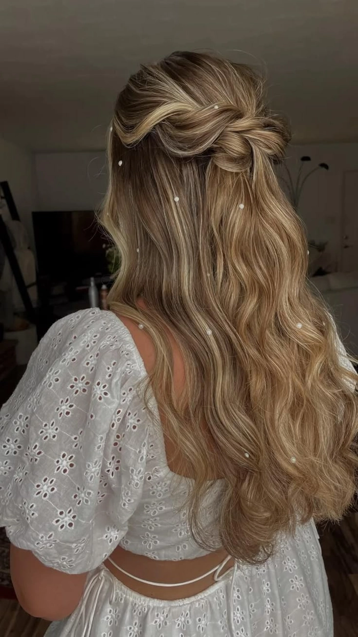 Elegant prom updo adorned with delicate pearl hair accessories