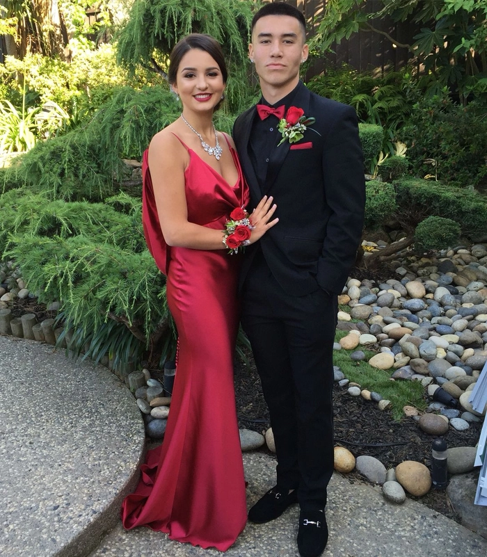 Elegant prom updo hairstyle perfectly complementing a vibrant red dress