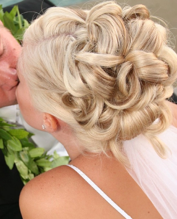 Chic prom updos for short layered hair showcasing stylish and sophisticated looks Elegant prom updo hairstyle for short layered hair with soft curls and volume