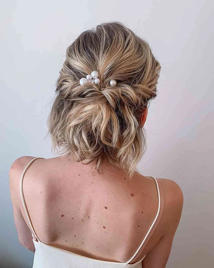 Stunning prom hairstyle idea featuring a chic updo for short layered locks Elegant prom updo for short layered hair with soft curls and volume