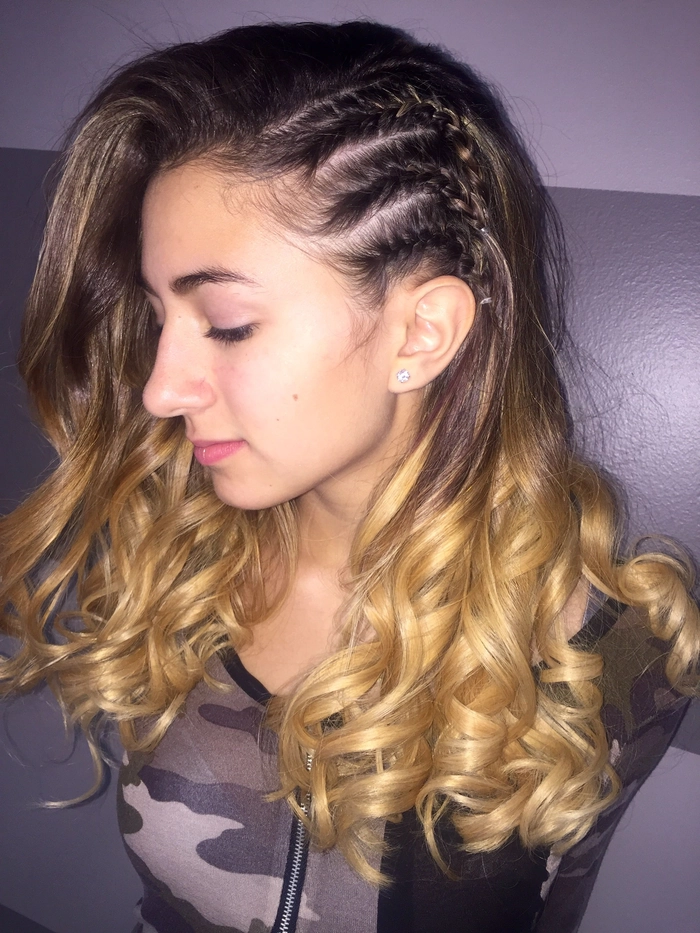 Elegant prom hairstyle featuring multiple small braids woven into a chic updo