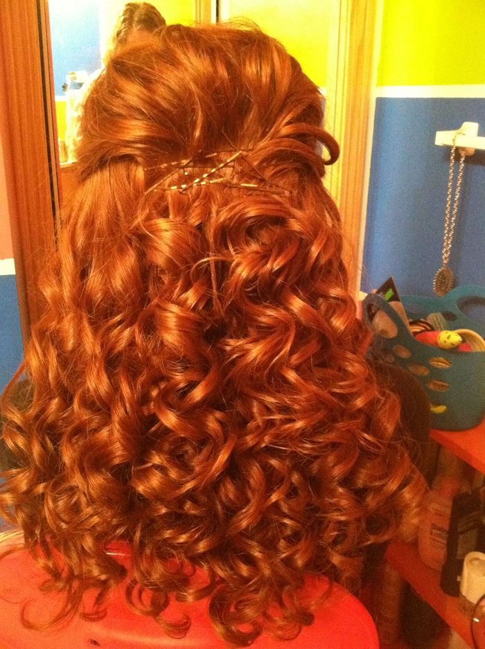 Elegant prom hairstyle showcasing vibrant red hair with soft curls