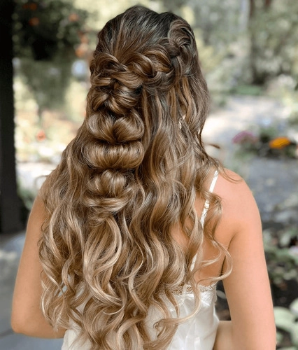 Elegant prom hairstyle with flowing waves styled for a beach venue