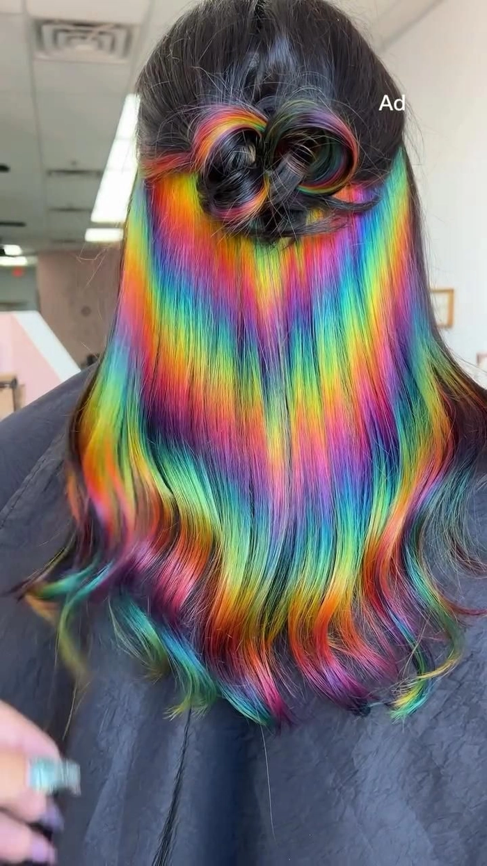 Elegant prom hairstyle showcasing vivid rainbow color treated hair with intricate braids