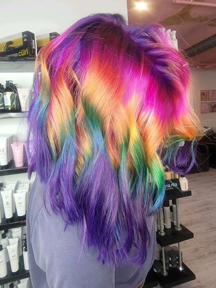 Elegant prom hairstyle showcasing vivid rainbow color treated hair in soft curls