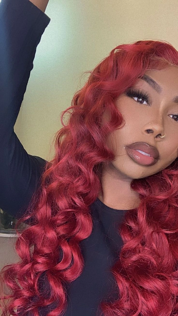 Elegant prom hairstyle showcasing vibrant red hair with soft curls and delicate accessories