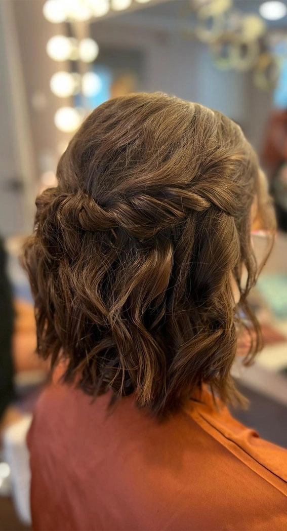 Elegant prom hairstyle featuring a short bob haircut with soft curls and delicate accessories