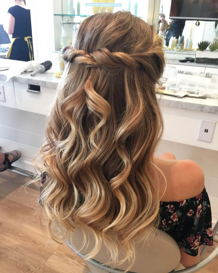 Elegant prom hairstyle featuring a side-swept look perfect for one shoulder gowns