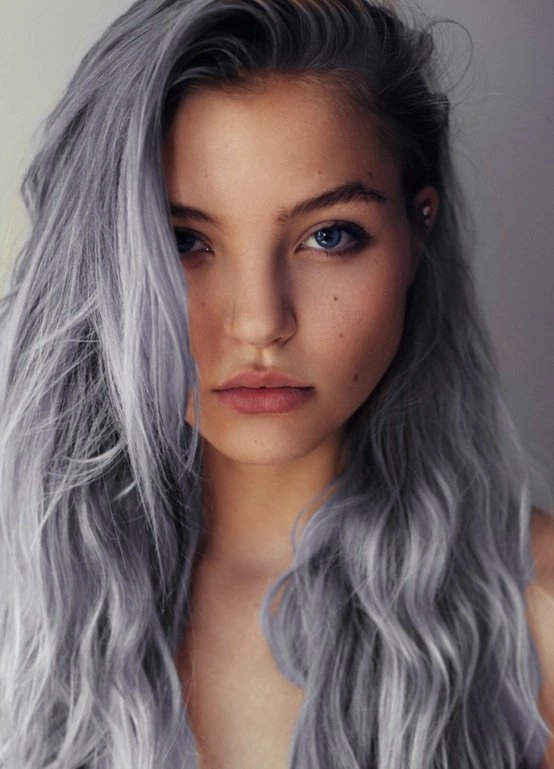 Elegant prom hairstyle featuring silver grey hair styled with soft curls and a jeweled hairpin