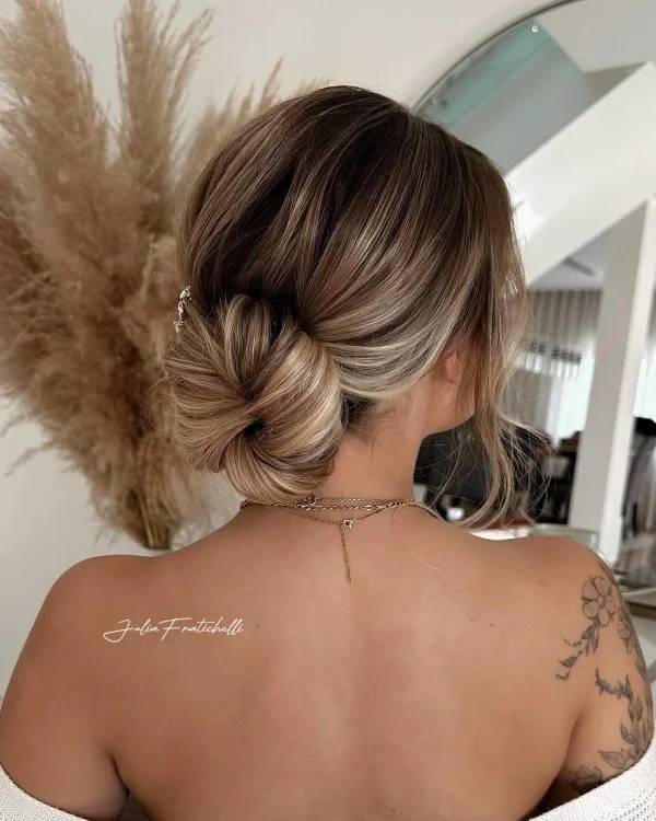 Chic summer prom hairstyle idea number 7 perfect for staying cool and stylish Elegant summer prom hairstyle suitable for hot weather with soft curls and a floral accessory