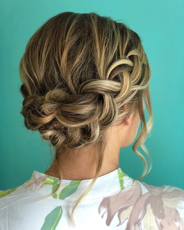 Elegant prom hairstyle featuring a twisted halo braid with loose curls