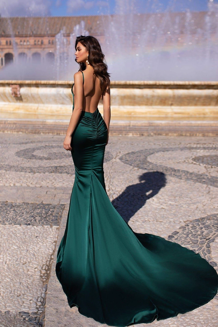 Elegant updo featuring delicate curls perfect for prom hairstyles to match a green dress