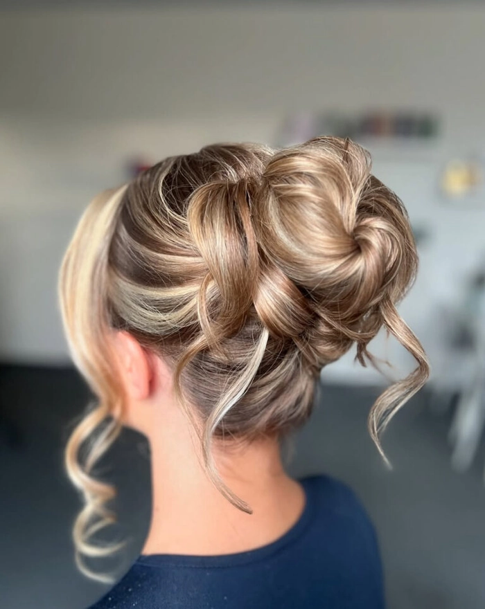 Sophisticated prom hairstyle with flowers for an outdoor garden setting Elegant updo with delicate floral accents perfect for prom hairstyles for a garden venue