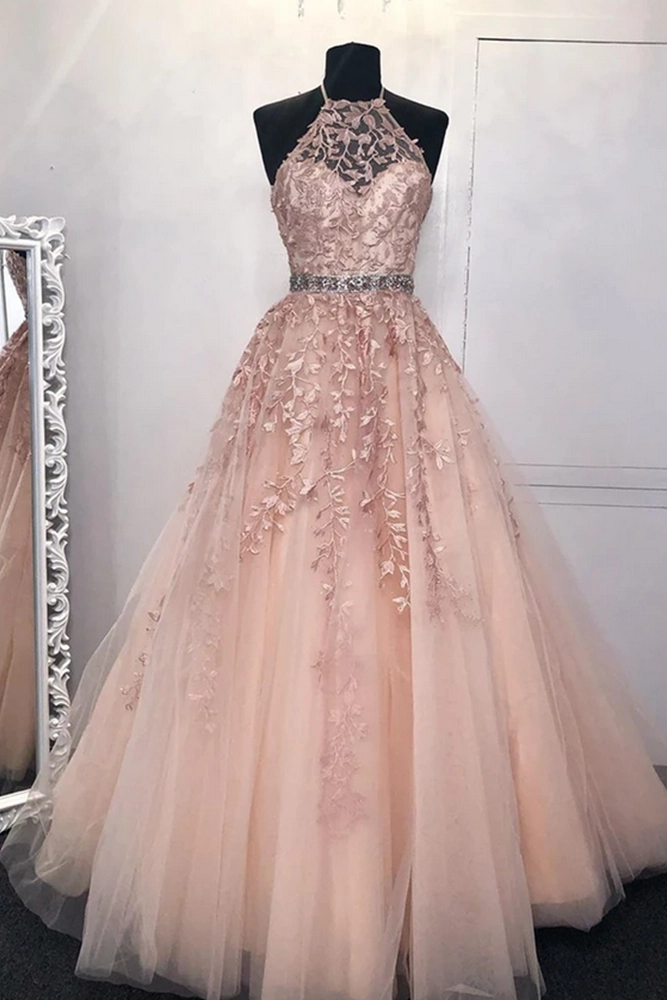 Elegant updo hairstyle complementing a halter neck prom dress