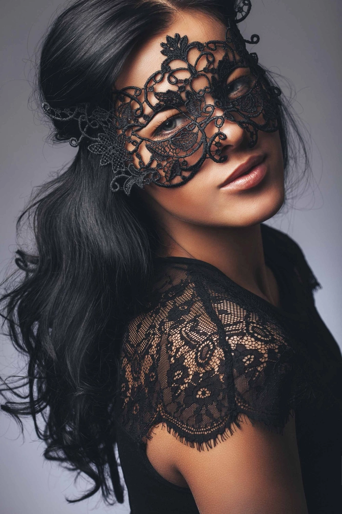 Elegant updo for masquerade ball prom hairstyles with intricate mask accessory
