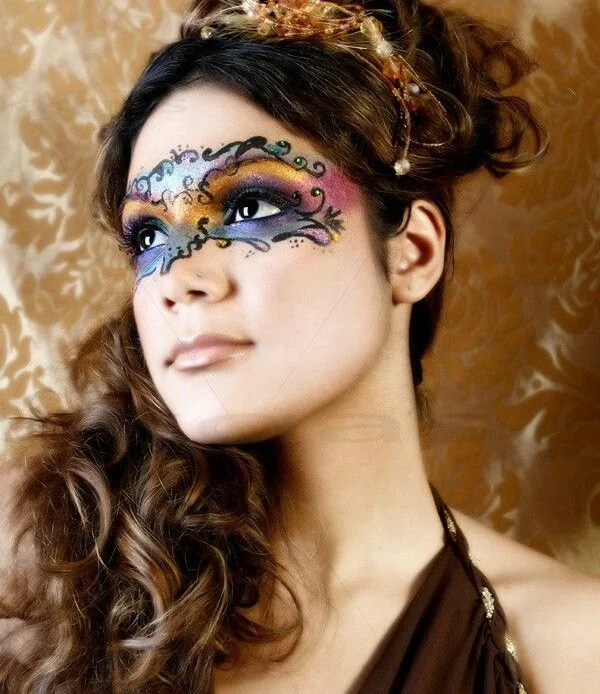 Elegant updo with intricate mask details for a masquerade ball prom hairstyle