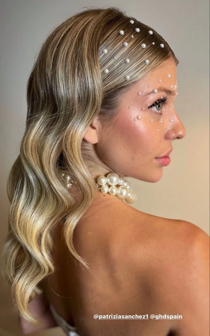 Elegant updo featuring delicate pearl hair accessories perfect for prom