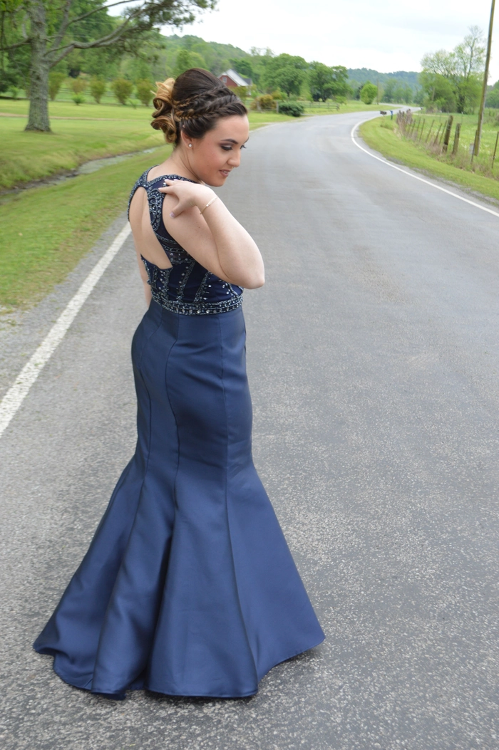 Chic prom hairstyle complementing a stunning backless gown Elegant updo hairstyle perfect for prom with a backless formal dress