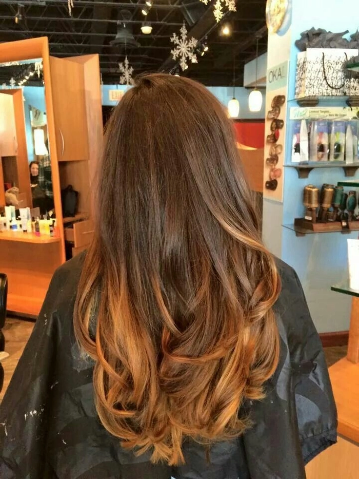 Elegant updo prom hairstyle showcasing caramel ombre hair with soft curls