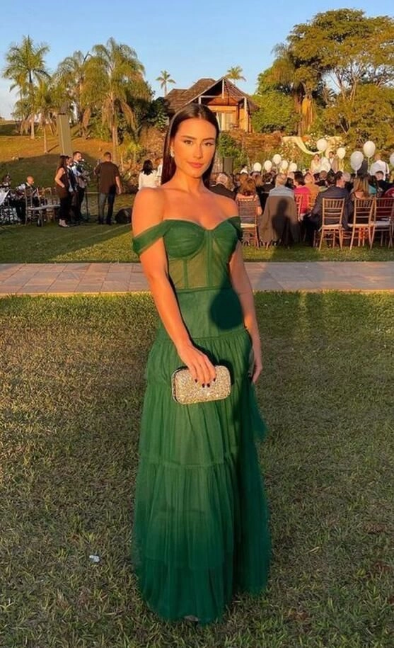 Elegant updo prom hairstyle perfectly complementing a green dress