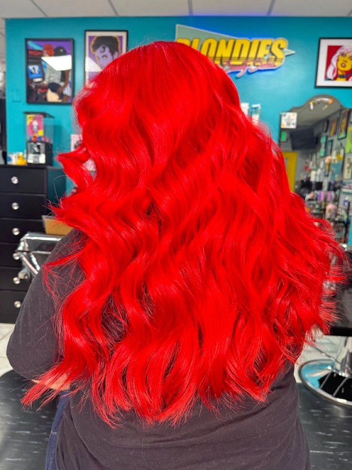 Elegant updo prom hairstyle for vibrant red hair with intricate braids