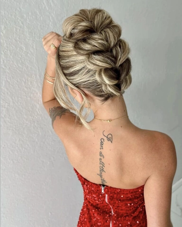 Elegant updo with soft curls complementing a blue prom dress