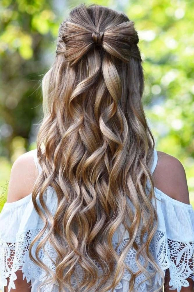 Elegant updo with soft curls styled for prom to complement a white dress