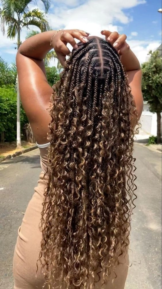 Ethereal goddess braided prom hairstyle with delicate twists and floral accents