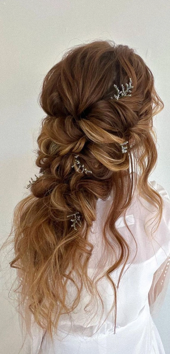 Romantic fairy tale princess prom hairstyle with soft curls and delicate floral accents