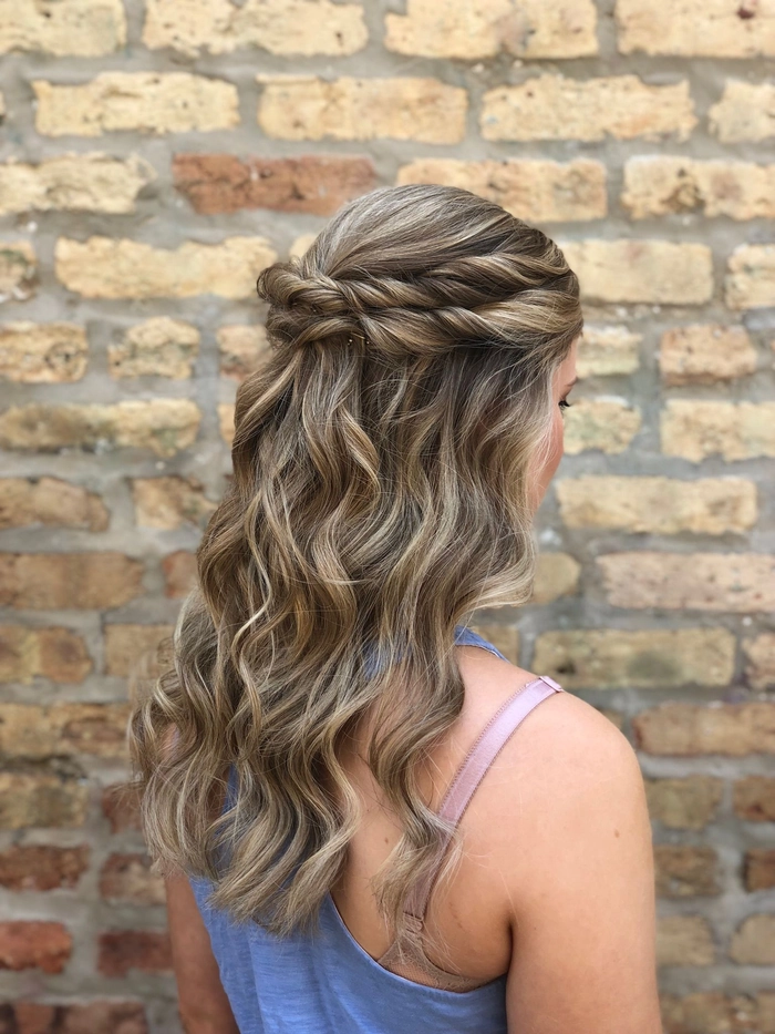 Romantic fairy tale princess prom hairstyle with intricate curls and floral accessories
