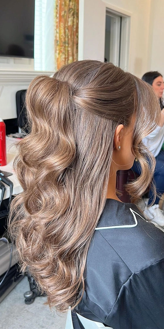 Stunning curly half up half down prom hairstyle for a glamorous look Half up half down prom hairstyle featuring elegant curls and soft volume