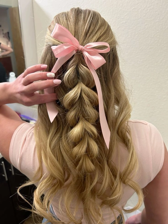 Junior prom hairstyle featuring loose curls and a floral accessory for middle school students