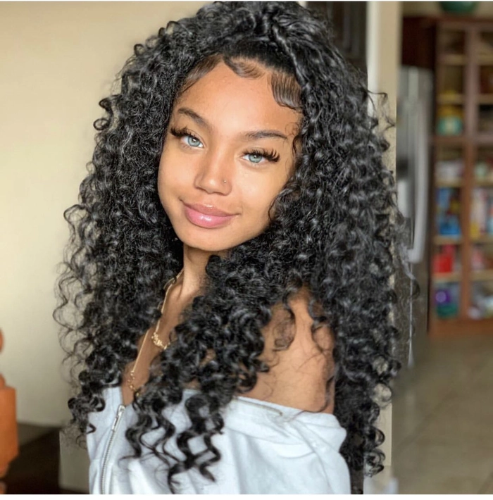 Long natural curly hair styled in an elegant long prom hairstyle with delicate accessories