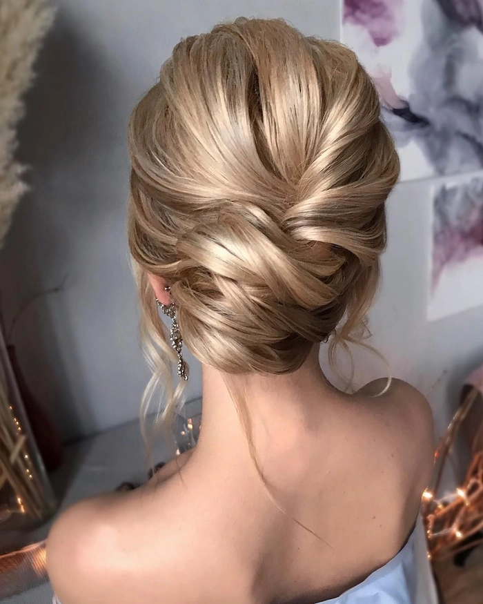 Elegant masquerade ball prom hairstyle with intricate curls and a decorative mask