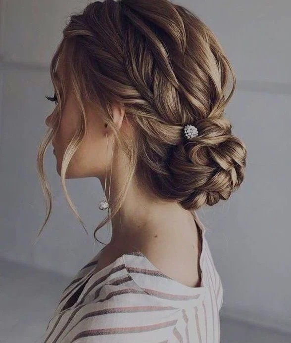 Elegant masquerade ball prom hairstyle with intricate curls and decorative mask