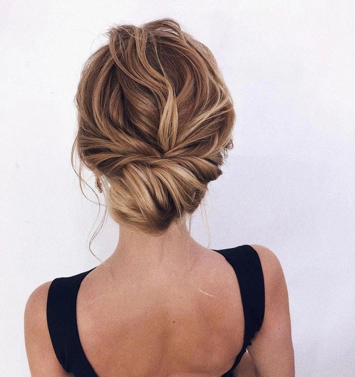 Messy French twist prom hairstyle with loose tendrils and volume