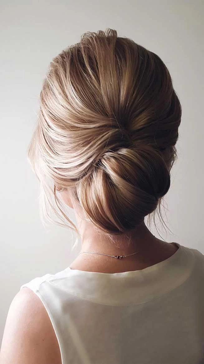 Messy French twist prom hairstyle with loose curls and elegant volume