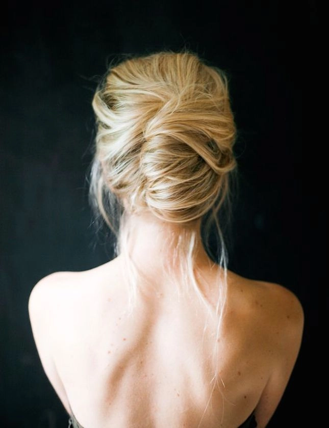 Messy French twist prom hairstyle with loose strands and volume