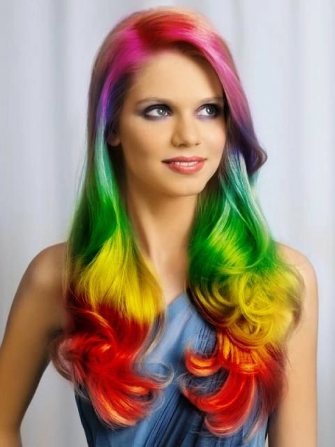 Prom hairstyle featuring vivid rainbow color treated hair styled in loose curls