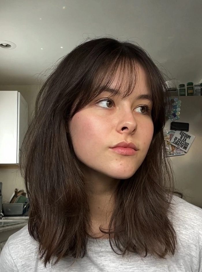 Stylish prom look with curtain fringe and flowing curls perfect for formal events Elegant prom hairstyle featuring bangs and curtain fringe with soft curls