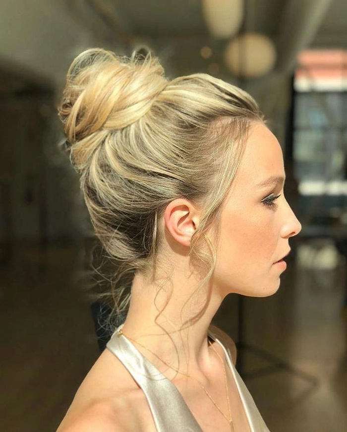 Prom hairstyle featuring a high messy bun perfect for a stylish prom look